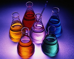 collection of flasks containing bright colored liquid